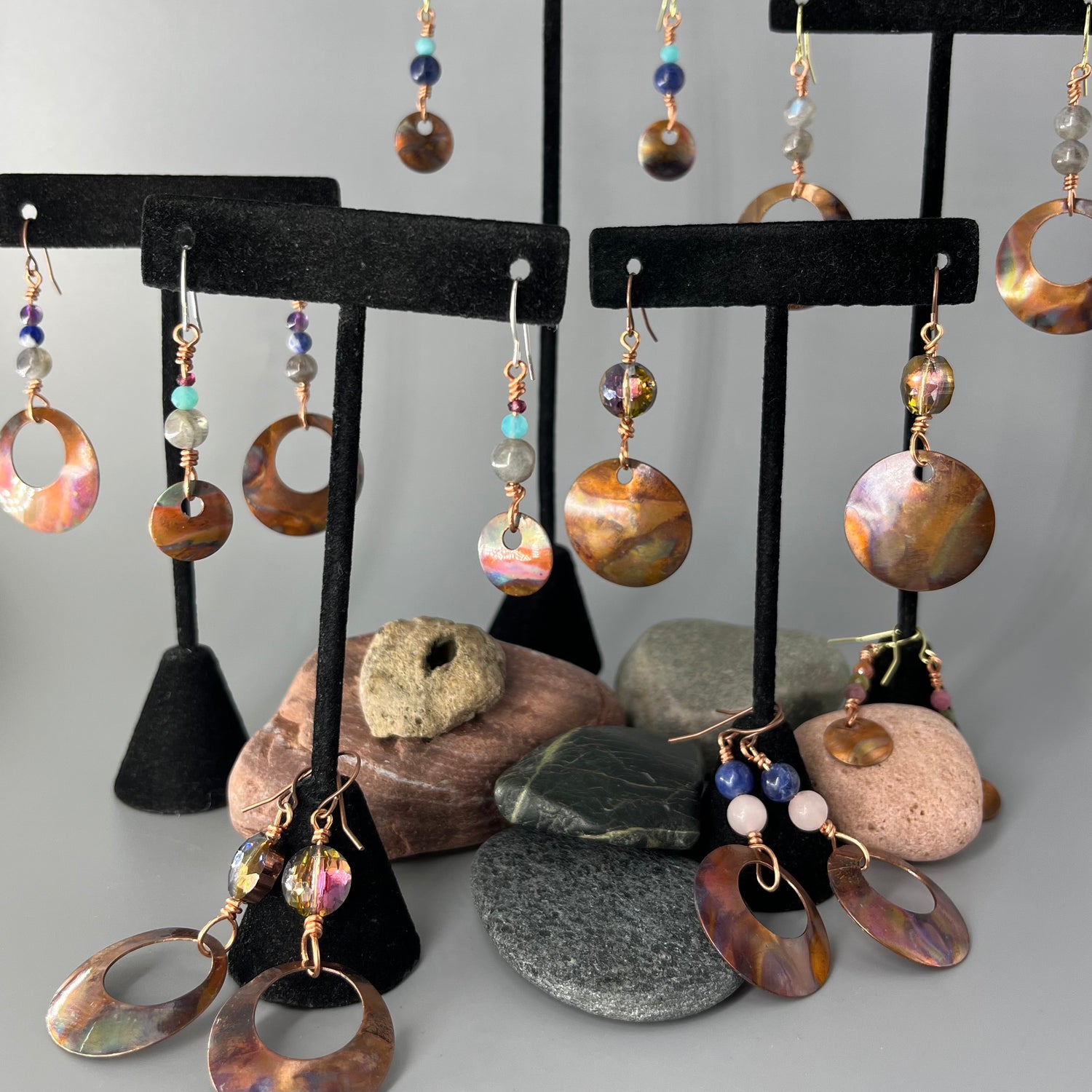 Selection of copper dangle earrings accented with stone and glass.